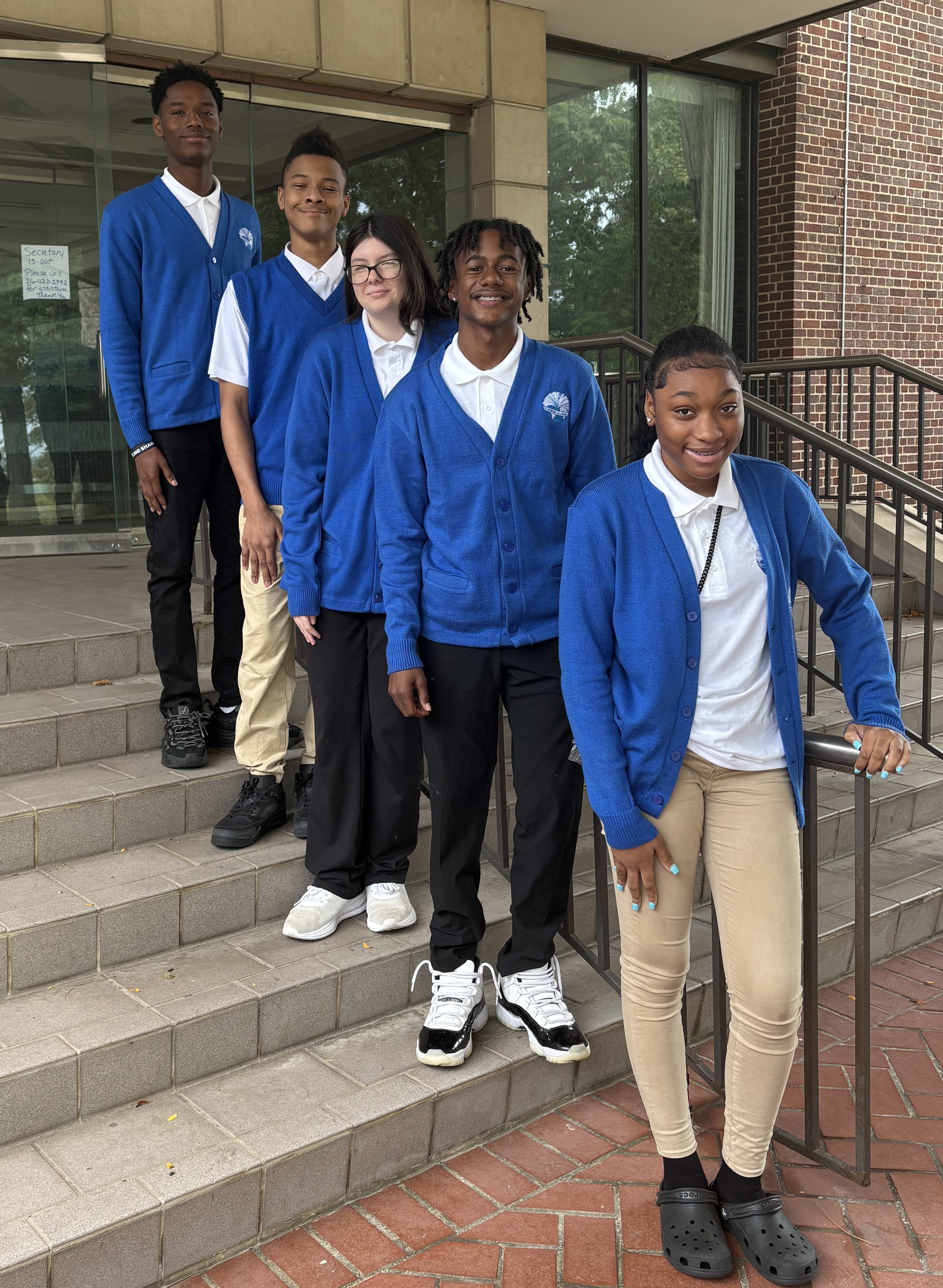 Students standing on steps outside the school